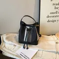 Retro striped bucket bag featuring black and white woven texture and faux leather trim - Black