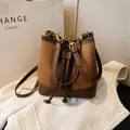 Vintage brown patchwork bucket bag with drawstring closure and woven leather texture - Brown