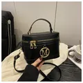 Minimalist black box handbag with golden M logo and adjustable shoulder strap - Black