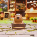 Close-up of cute Capybara resin figure with pink cheeks taking a bath in a wooden tub - Bathing Capybara (HX-059)