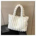 Detail of white faux fur tote bag with vertical stripes and plush ball handle - White