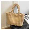 Detail of beige faux fur tote bag with vertical stripes and plush ball handle - Khaki
