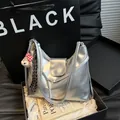Silver metallic leather shoulder bag with plush charm and minimalist branding - With Pendant / Silver