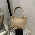 Minimalist beige lychee grain bucket bag with top handles for professional women - Khaki