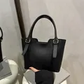 Chic black litchi grain leather tote bag with gold hardware for elegant daily use - Black