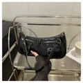 Glossy black underarm shoulder bag with double pockets and metallic buckle details - Black