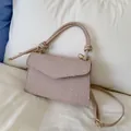 Minimalist light pink crossbody bag with textured dot embroidery and knotted handle - Pink