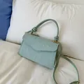 Chic mint green handbag with raised dot texture and adjustable shoulder strap - Green
