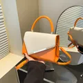 Orange and cream stylish crossbody bag with silver metal bar and adjustable strap - Orange