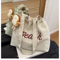 Off-white canvas tote bag with red Beach print and cute plush toast accessory - With Pendant / White