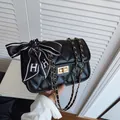 Quilted black leather crossbody bag with gold chain and silk bow scarf detail - Black
