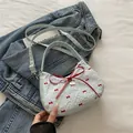 Light blue bubble crepe handbag with red bow print and silver heart pendant detail - No Pendant / Light Blue