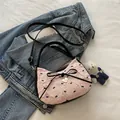 Pink pleated tote bag with black bow embroidery and heart pendant in a cozy setting - With Pendant / Pink