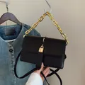 Classic black leather crossbody square bag featuring a bold gold chain and padlock - Black