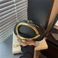 Chic black pillow bag with large gold metal ring handle and crossbody chain strap - Black