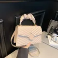 Beige quilted crossbody bag with ruffled handle and square metal lock in cream finish - Khaki