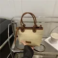 Handwoven straw bucket bag with dark brown leather handles and adjustable shoulder strap - Dark Brown