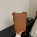 Brown litchi grain leather bucket bag with embossed logo and slim shoulder strap - Dark Brown