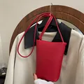 Red lychee grain leather small bucket bag with thin shoulder strap and front logo - Red