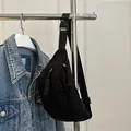 Minimalist black corduroy chest bag with adjustable nylon strap and woven zipper pulls - Black