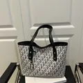 Classic black and white monogram tote bag with faux leather handles and gold pendant - Black