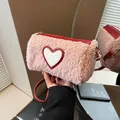 Pink cylinder crossbody bag in faux shearling with red heart patch and slim strap - Pink
