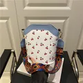 White cherry print bucket bag with blue trim and ethnic pattern wide shoulder strap - Blue