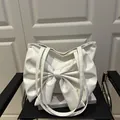 White faux leather tote bag with large 3D bow design and long double shoulder straps - White