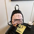 Mini mochila de tela burbuja rosa con estampados de flores y lazos negros y cinta frontal - Negro