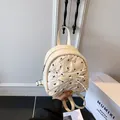 Mini mochila crema con textura plisada y pequeños lazos bordados negros - Blanco