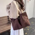 Women's dark brown suede tote bag featuring silver metal accents and long handles - Brown