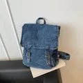 Vintage blue washed denim backpack with adjustable metal buckles and top handle design - Dark Blue