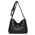 Classic black leather crossbody bag with multiple zip pockets and adjustable strap - Black