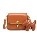 Classic tan crossbody bag with golden teardrop lock and a cute dog charm attachment - Puppy Charm Style / Brown