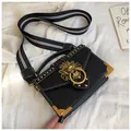 Black pebbled leather square bag with gold lion buckle and striped wide strap - Black