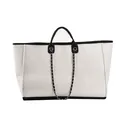 Detail of white woven tote bag featuring black leather trim and silver metal chain accessory - Large White