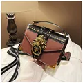 Brown and black retro rivet handbag with lion head detail and striped wide strap - Tan