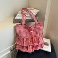 Red and white checkered canvas tote bag with ruffle details and drawstring closure - Red
