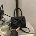 Sparkly black bow handbag with pearl handle and sequins for elegant evening shoulder wear - Black