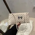 Retro cream shoulder bag with brown M-pattern print and silver metal bow detail - M Rice