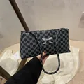 Black rectangular shoulder bag with M-pattern print and silver bow detail - M Black