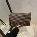 Minimalist crossbody flap bag in brown and black geometric dot pattern with strap - Monogram Coffee