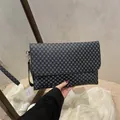 Black rectangular envelope clutch with blue polka dot pattern and leather wrist strap - Monogram Black