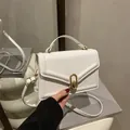 Elegant white envelope handbag with golden ring buckle and top handle in a minimalist style - White