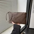 Vintage dark brown crossbody bag with gold circular patterns and slim wrist strap - Clover Coffee