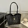 Chic grey star pattern tote bag with gold metal buckle and dual straps in a modern setting - Black