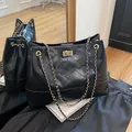 Elegante bolso tote acolchado negro con cierre de giro dorado y correa de cadena - Negro