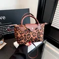 Stylish leopard print nylon dumpling handbag with brown leather handles and shoulder strap - Dark Brown