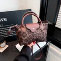 Stylish leopard print nylon dumpling handbag with leather handles and crossbody strap - Coffee