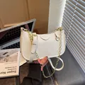 White litchi grain underarm bag with gold chain and cute strawberry charm accessory - White